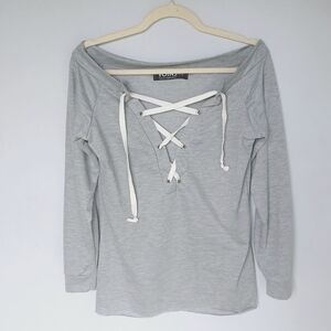 Lace up Grey Top Long Sleeve Shirt Raw hem shown in closeup photo. Off Shoulder